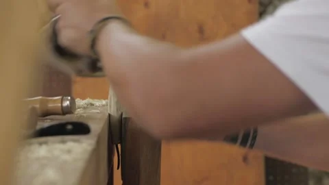 A joiner planes a wooden handle for a chisel with a large plane. fhd. 24 fps Stock Footage 137150027