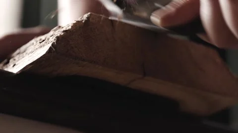Joiner processes the edges of an oak wood board with spokeshave. carpenter us Stock Footage 166082290