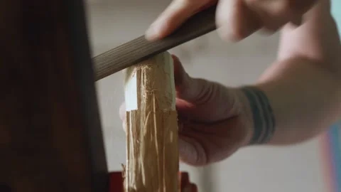 A joiner processes a piece of wood with a file. the sound of carpentry tools Stock Footage 156683121