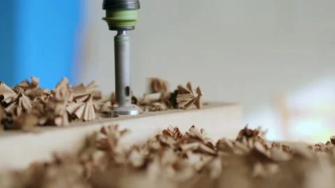 A joiner processes a walnut board with a wood cutter. the art of woodworking  Stock Footage 144243828