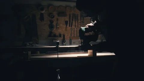 Joiner use electric jigsaw. Tools in a carpentry workshop. Jigsaw for carving wo Stock Footage 78438155