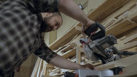 Joiner uses a circular saw machine Stock Footage 102432348