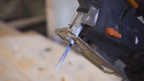 Joiner working with jigsaw in hand. Close up of an electric jigsaw on a tree. Stock Footage 99783672