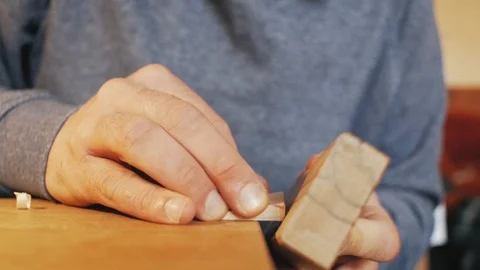 Joiner's hands planing a wooden comb with a plane.handmade Stock Footage 100643520