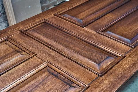 Joinery. Door leaf, painted in dark color. Wood door manufacturing process Stock Photos