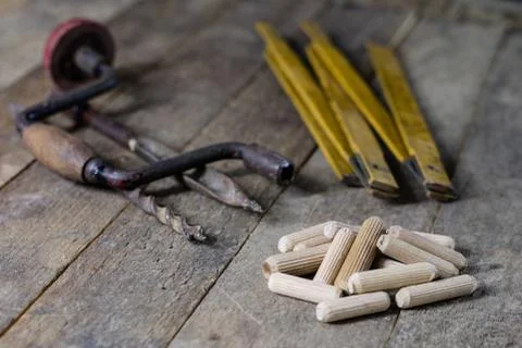 Joinery tools in a workshop. Drill, hammer and other tools on a wooden worksh Stock Photos