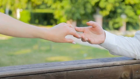 Joining 2 hands as a sign of love and loyalty. Summer. in the background, the Stock-Footage 122265743