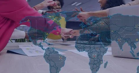 Joining five colleagues placing hands in conference room, showing map overlay, Stock Photos