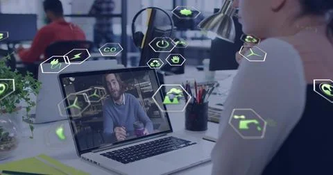 Joining office worker connecting on laptop with man holding cup at open-plan Stock Photos