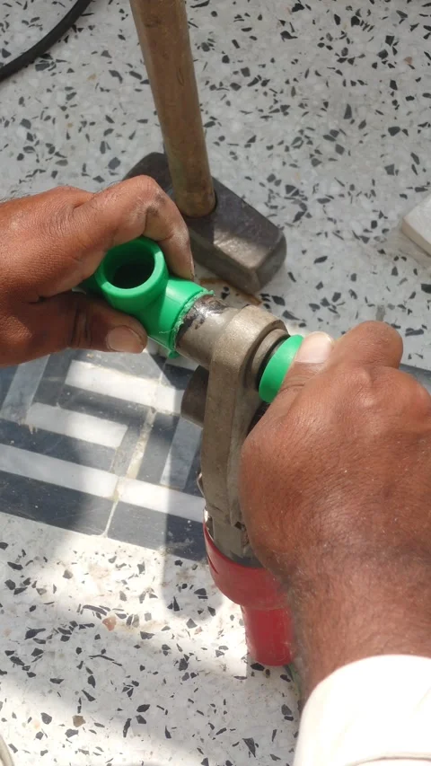 Joining Two Green PPR Pipe Pieces With Heated Welding Machine, First Person POV Stock Footage 346595732