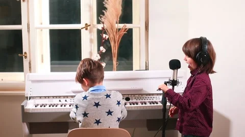 Joint children's creativity. Two boys elementary music school students rehearse. Stock Footage 146931416