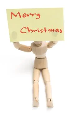 Joint dolls holding yellow notes with Merry Christmas Stock-Fotos