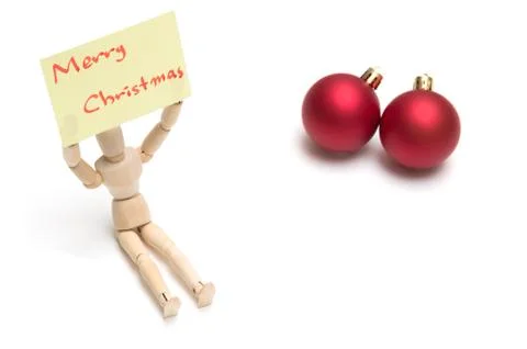 Joint dolls holding yellow notes with Merry Christmas and christmas ball Foto stock