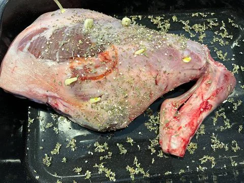 A joint of lamb being prepared for cooking Stock Photos
