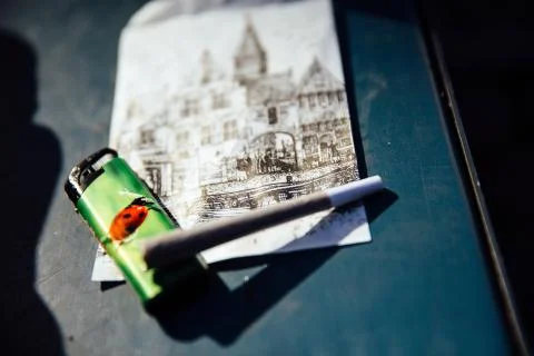 Joint is lying on a postcard with a view of Amsterdam Stock Photos