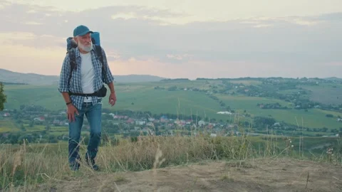 Joint Support, Active Aging. Senior Man Hikes Mountains Despite Knee and Back Stock Footage 306940065