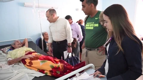 Joint Task Force surgeons speaking to patient in bed Stock Footage 84936588