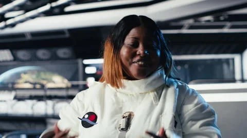 Jolly astronaut waves hand during videocall with Earth command center Video stock 310969958