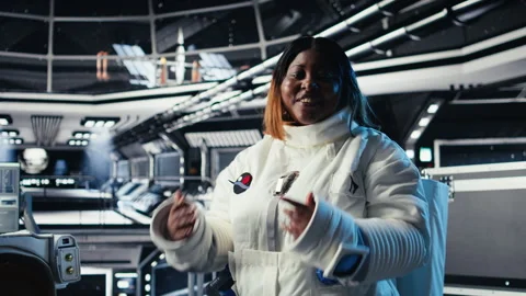 Jolly astronaut waves hand during videocall with Earth command center Video stock 311310064