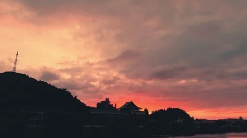 Jolly colorful sunset exploding sky in vivid colors over Japanese buildings Stock Footage 94037356