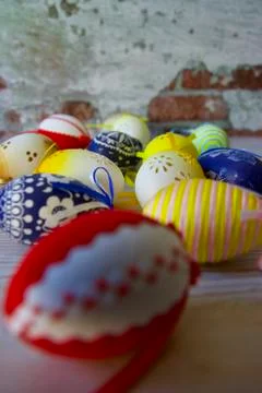 Jolly colourful Easter eggs stacked on a table Stock Photos