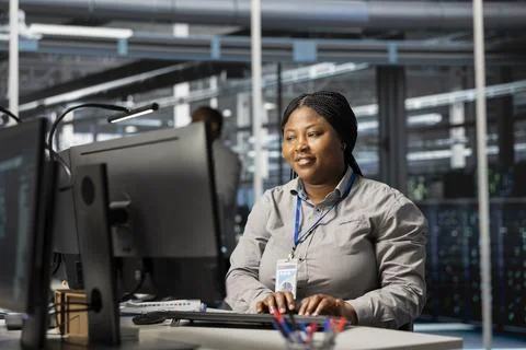 Jolly data center admin analyzing software logs metrics on PC Stock Photos