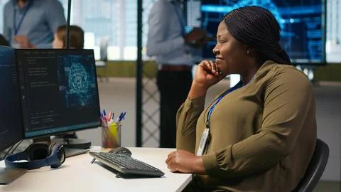 Jolly female programmer at office desk pleased after developing application 스톡 사진
