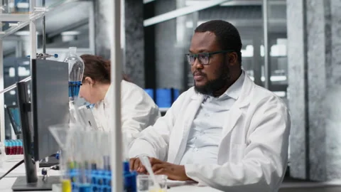 Jolly laboratory researcher using computer monitor Stock Footage 320143351