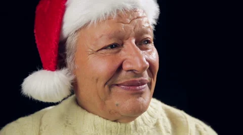 Jolly Old Man With Santa Cap Pointing At Red Gift Stock Footage 44113983