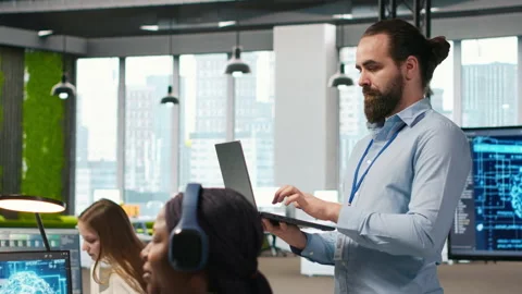 Jolly programmer coding AI algorithms on laptop to debug software issues Stock Footage 313015354