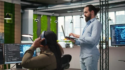 Jolly programmer coding AI algorithms on laptop to debug software issues Stock Footage 313165709