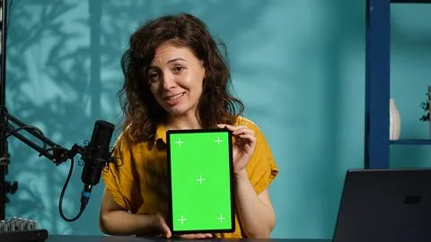 Jolly woman filming tech tutorial on how to repair damaged mockup tablet Stock Photos