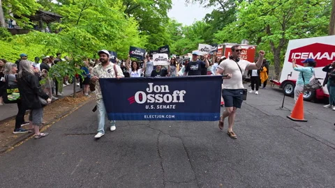 Jon Ossoff supporters carry banner and signs in Atlanta parade Stock-Footage 342365041