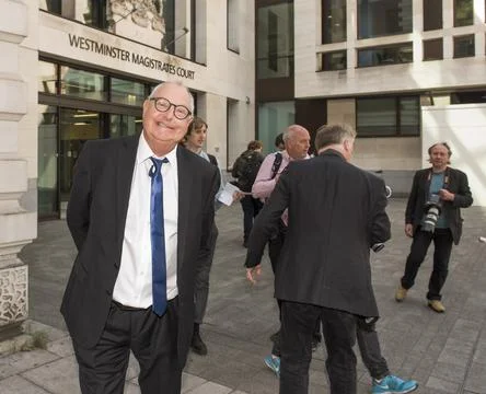 Jonathan King, 72, waves as he enters court to face 18 historical sex offence ch Stock Photos