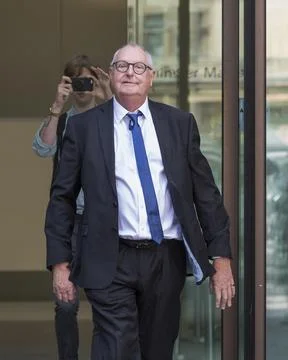 Jonathan King, 72, waves as he enters court to face 18 historical sex offence ch Stock Photos
