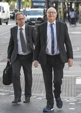 Jonathan King, 72, waves as he enters court to face 18 historical sex offence ch Stock Photos