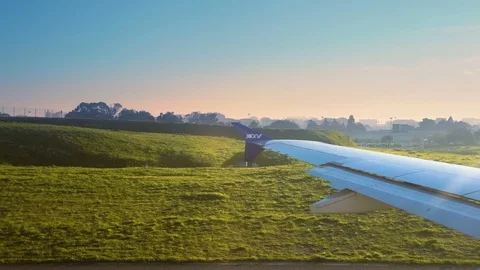 Joon airplane preparing for take off at sunset Lisbon airport Stock Footage 110817370