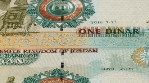 Jordan 1 dinar notes tracking. Jordanian currency. Slider shot, low angle. 4K Stock Footage 125998141