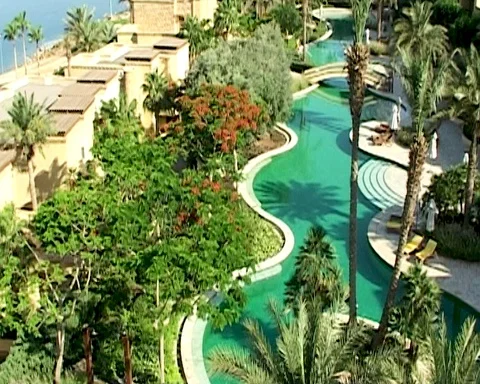 Jordan. Dead Sea. Pool with emerald water among palm trees. Hotel on beach. Stock Footage 126957748