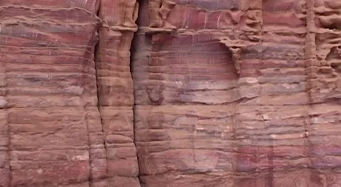 Jordan. Petra. Texture of layers of red sandstone on walls of cave temples. Stock Footage 149476872