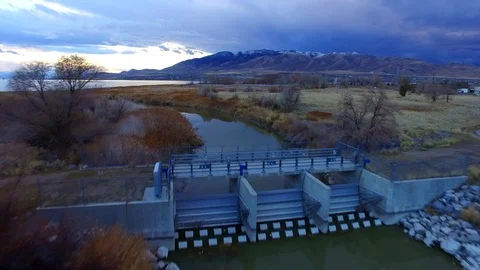 Jordan River Flyover with Utah Lake and Mountains Reveal 1 Stock Footage