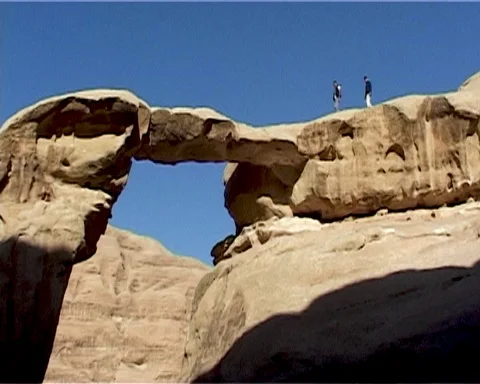 Jordan. Wadi Rum Desert. Two people walk along a rock. Vintage video. May 2011. Stock Footage 120721835
