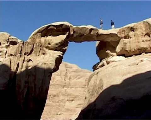 Jordan. Wadi Rum Desert. Two people walk along  rock. Vintage video. May 2011. Stock Footage 120721844