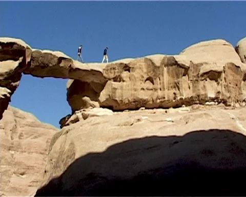 Jordan. Wadi Rum Desert. Two people walk along rock. Vintage video. May 2011. Stock Footage 120721859