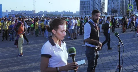 Journalist and operator RT among fans Stock Footage 99825950