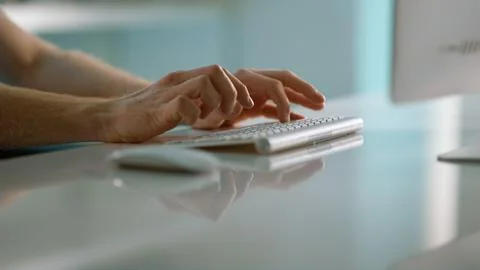Journalist hands typing article in office closeup. Unknown man working computer Foto stock