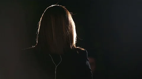 Journalist making a live broadcast in front of a spotlight Video stock 119984913