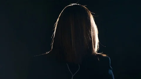 Journalist making a live broadcast in front of a spotlight Video stock 119984982