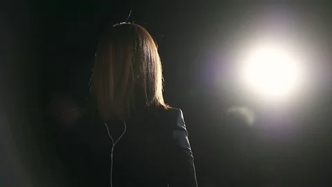 Journalist making a live broadcast in front of a spotlight Video stock 119985204