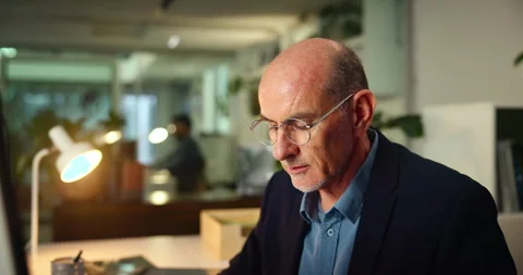 Journalist, mature man and computer in office for writing article, editing Video stock 300749937